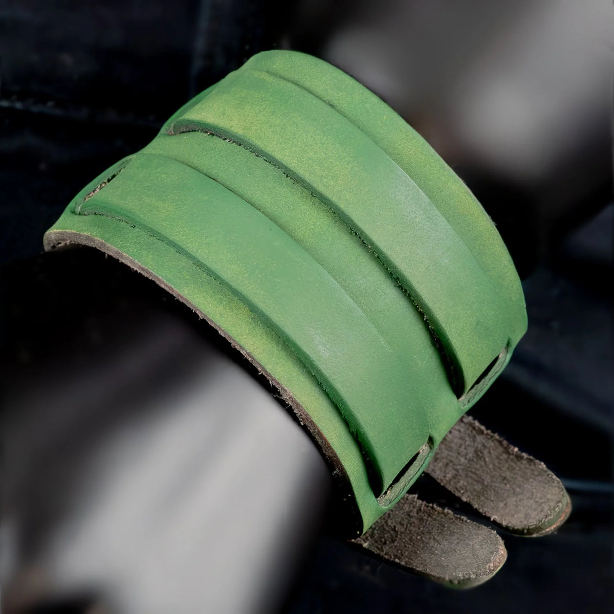 Green leather cuff bracelet with two straps.