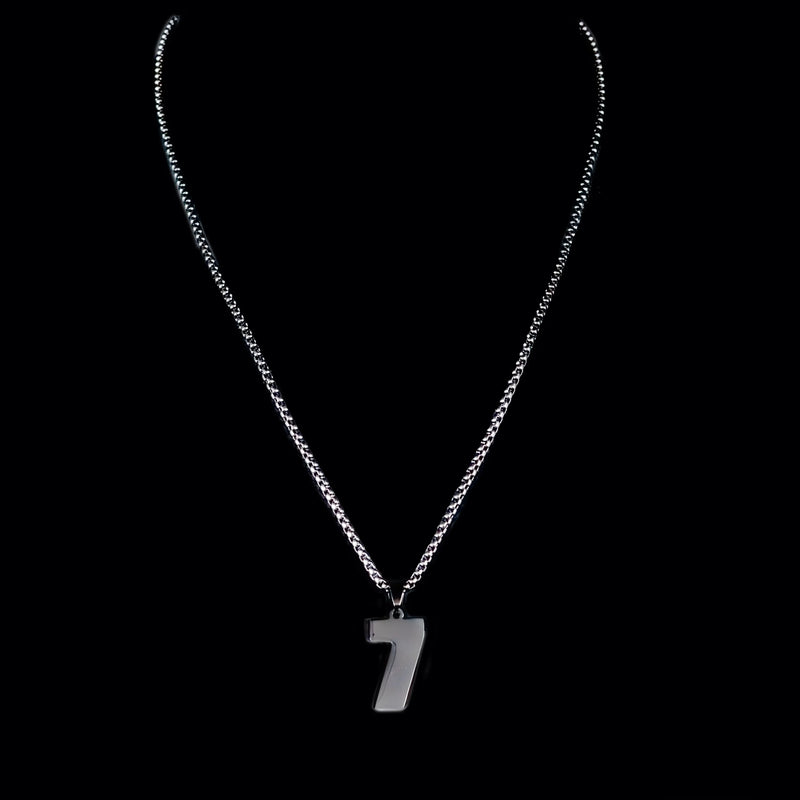 Silver necklace with a number 7 pendant.